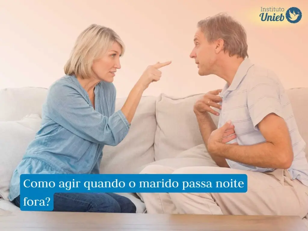Homem e mulher de frente para o outro sentados em um sofá discutindo a relação