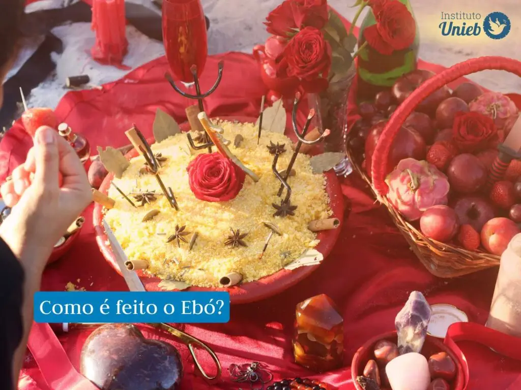 Oferenda preparada para Entidades Espirituais em vasilha vermelha, com farinha de milho, rosas vermelhas, canela em pau, anis estrelado, velas e outros elementos na cor vermelho