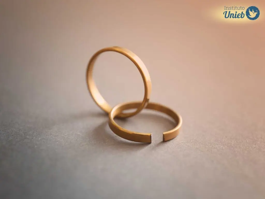 Duas alianças de ouro onde uma está inteira e outra quebrada