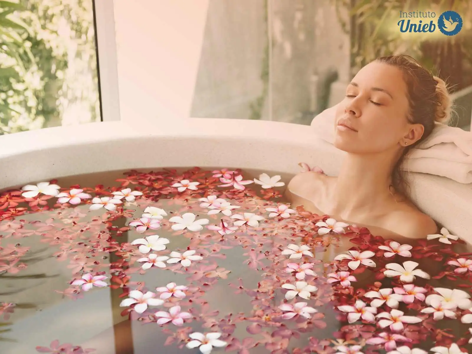 Mulher dentro de banheira com água e flores em tons de rosa e vermelho - Instituto Unieb (Pai de santo Roberson Dariel) - Contato 11 96982-1121 - CEP 14801-040 - Av. Dom Pedro II 562, Centro, Araraquara, SP