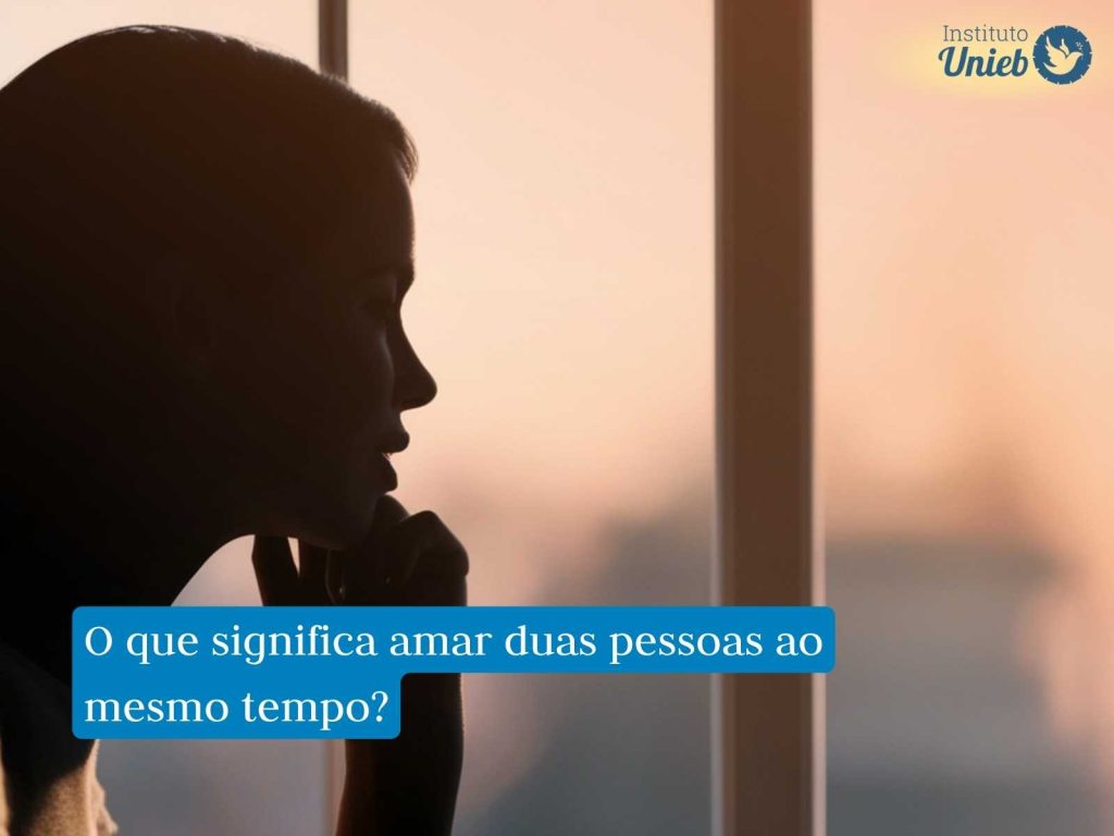 Mulher olhando pela janela representando alguém pensativo que reflete sobre amar duas pessoas ao mesmo tempo